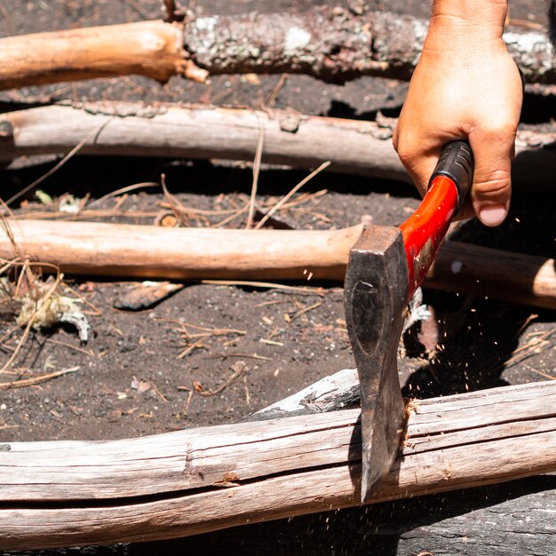 Man cutting woods with hatch