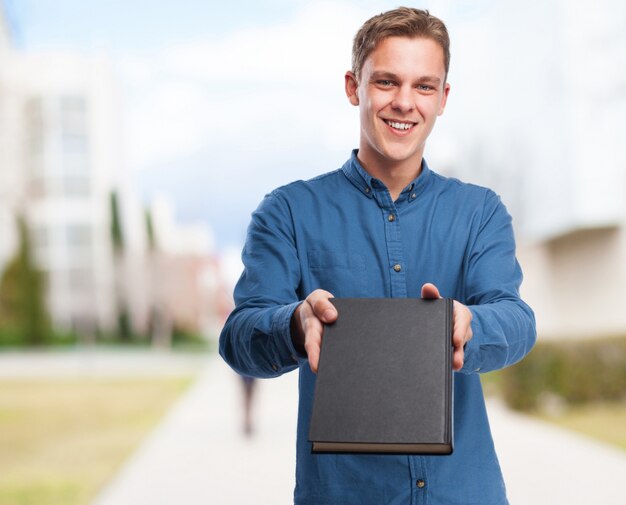 Man delivering a black notebook