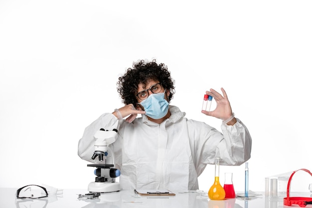 man doctor in protective suit and mask holding flasks on white