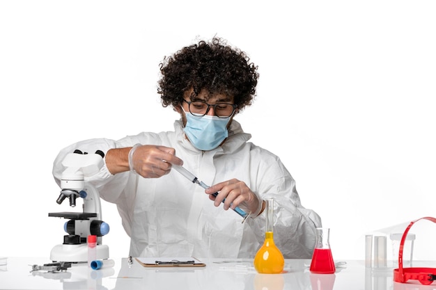 man doctor in protective suit and mask working with solution on white