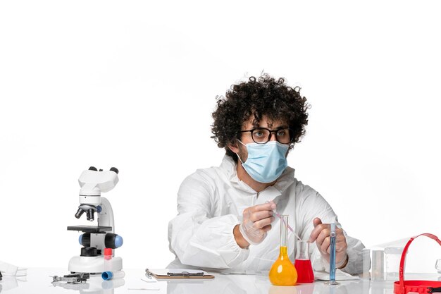 man doctor in protective suit and mask working with solutions on white