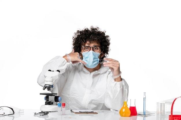 man doctor in protective suit sterile mask holding sample on light white