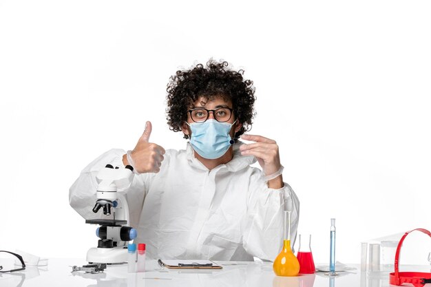 man doctor in protective suit sterile mask holding sample on white