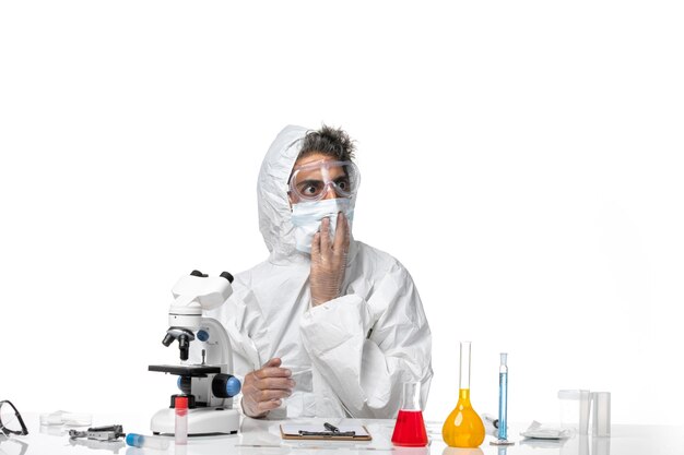 man doctor in protective suit and with sterile mask on white