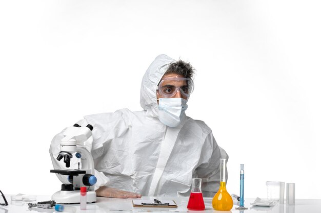 man doctor in protective suit with sterile mask on white