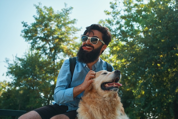 Man and dog having fun, playing, making funny faces