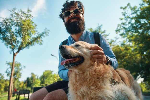 Man and dog having fun, playing, making funny faces