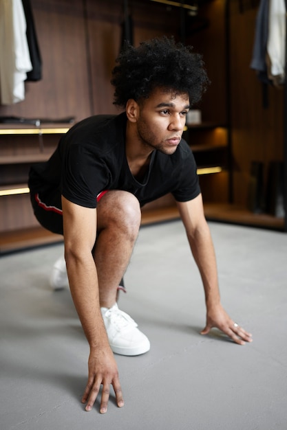 Man doing burpee in closet full shot