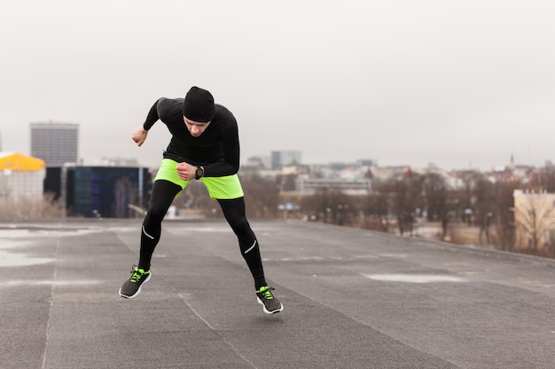 Man doing exercises on rooftop