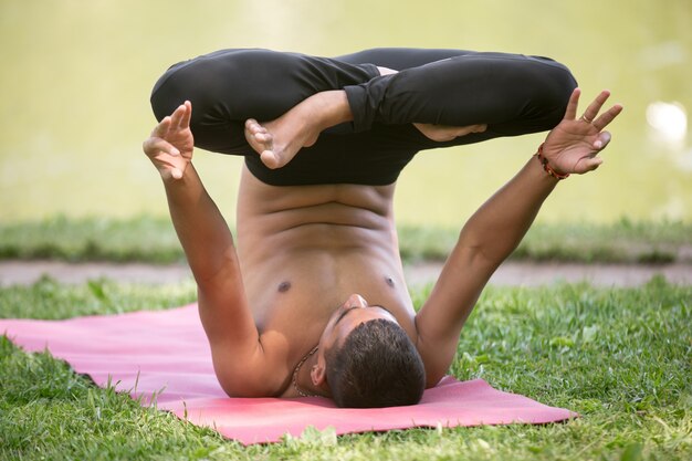 Man doing a handstand ith legs crossed