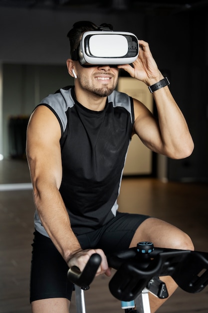 Man doing indoor cycling wit vr glasses