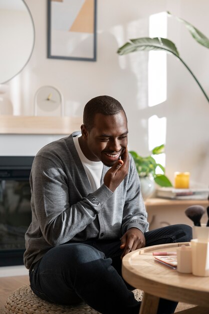 Man doing makeup indoors