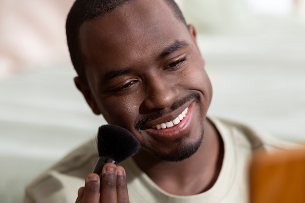 Man doing makeup indoors