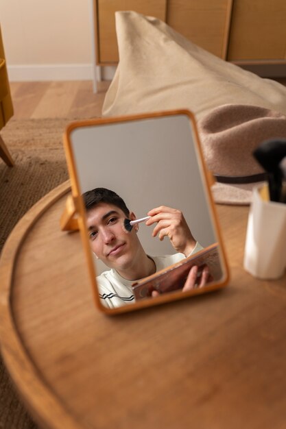 Man doing makeup indoors