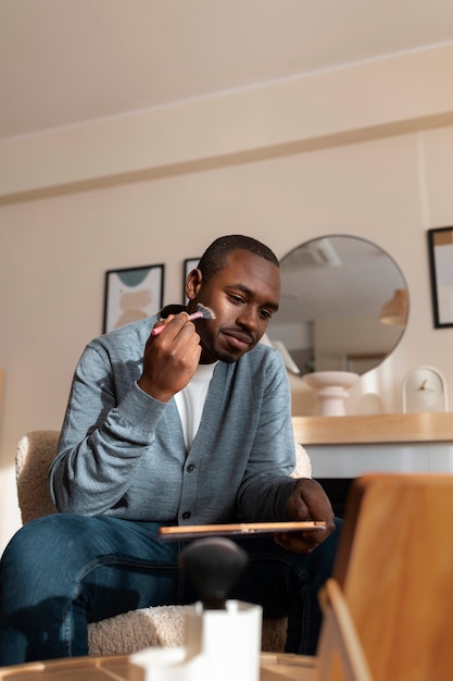 Man doing makeup indoors