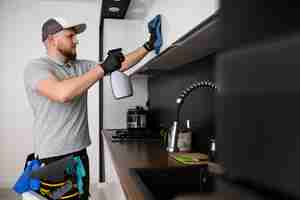 Free photo man doing professional home cleaning service