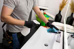 Free photo man doing professional home cleaning service