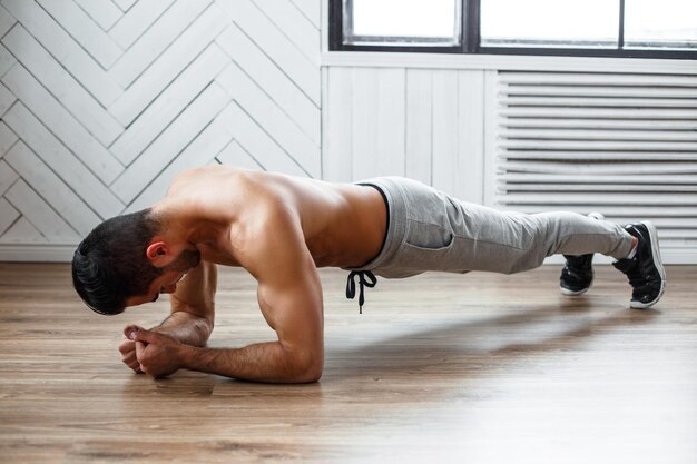 A man doing stomach workout on the floor.