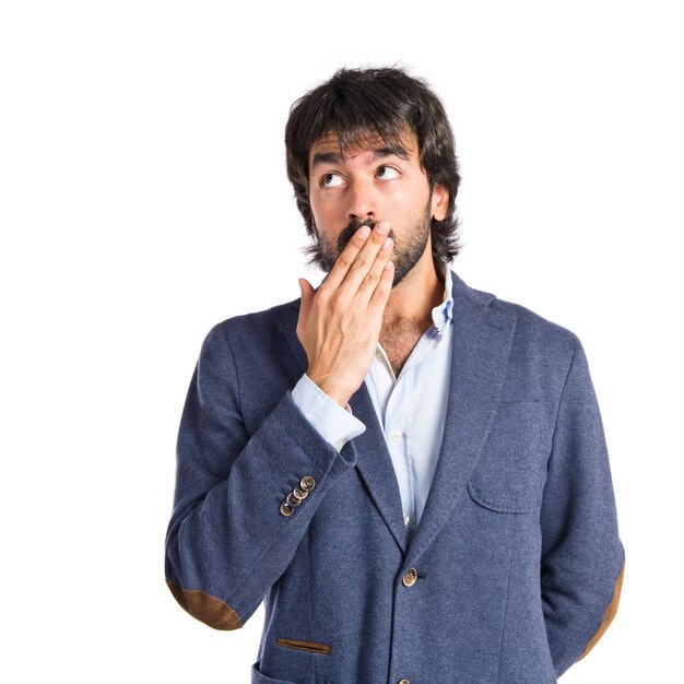 Man doing surprise gesture over white background