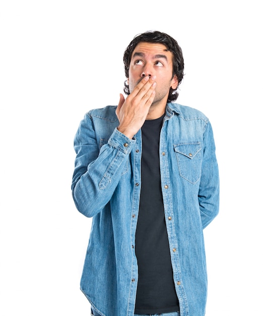 Man doing surprise gesture over white background