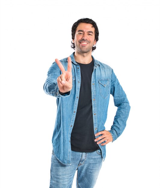 Man doing victory gesture over white background