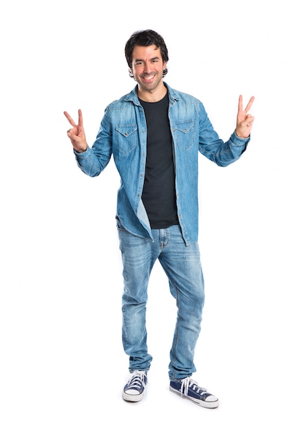 Man doing victory gesture over white background