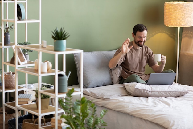 Man doing videoconference on bed