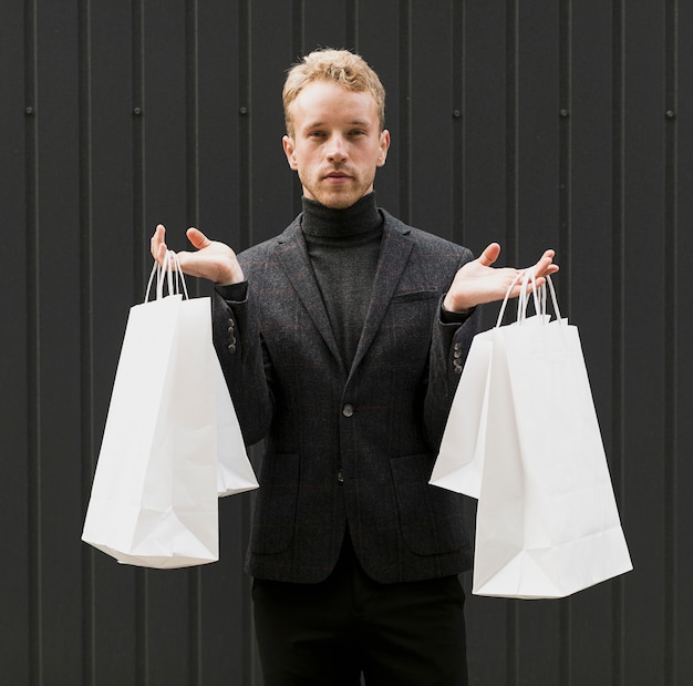 Man dressed in black with shopping bags