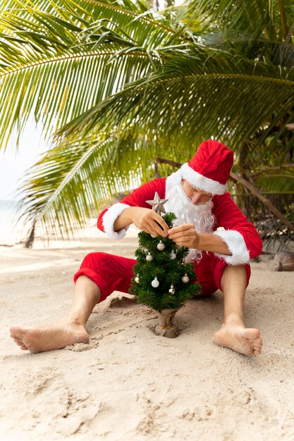 Man dressed in santa claus celebrating christmas in july