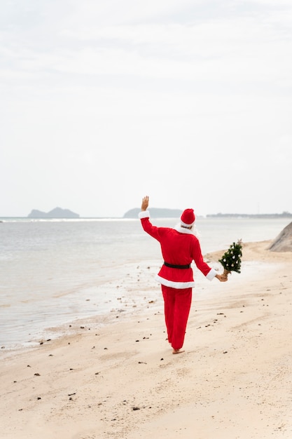 Man dressed in santa claus celebrating christmas in july