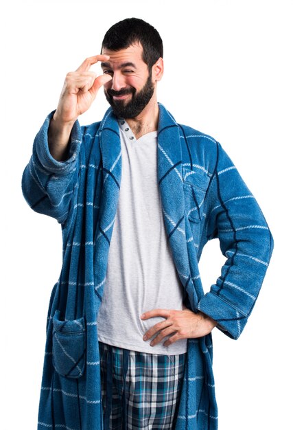 Man in dressing gown doing tiny sign