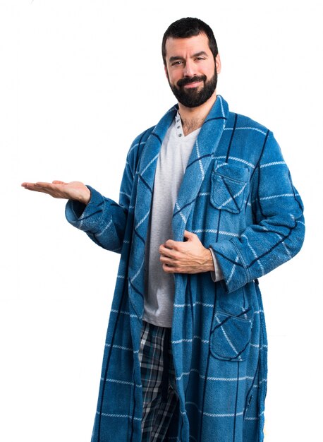 Man in dressing gown holding something