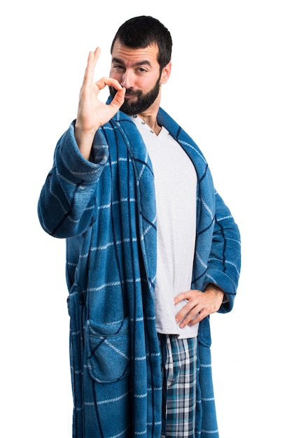 Man in dressing gown making OK sign