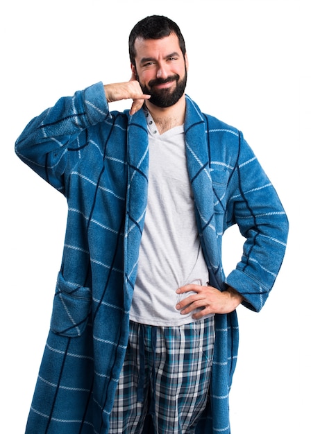 Man in dressing gown making phone gesture