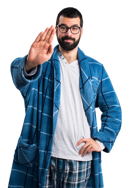 Man in dressing gown making stop sign