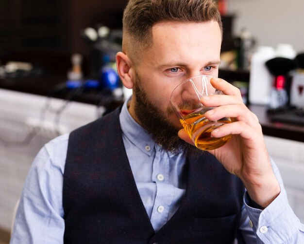 Man drinking at the barber shop