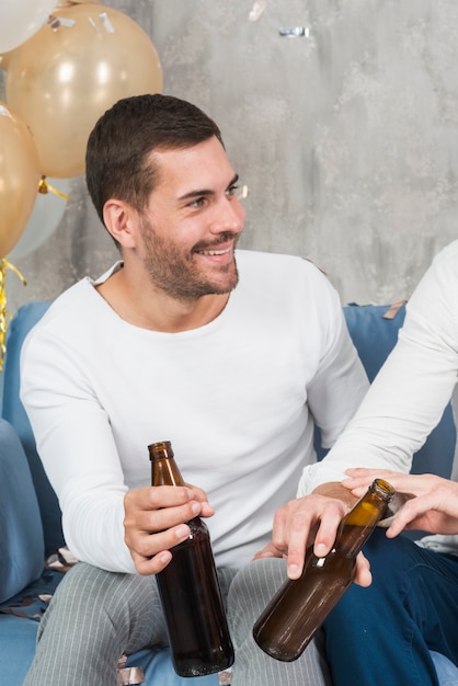 Man drinking beer with friend 