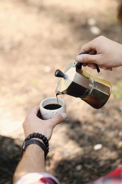 man drinking coffee in forest