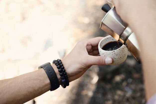 человек пьет кофе в лесу