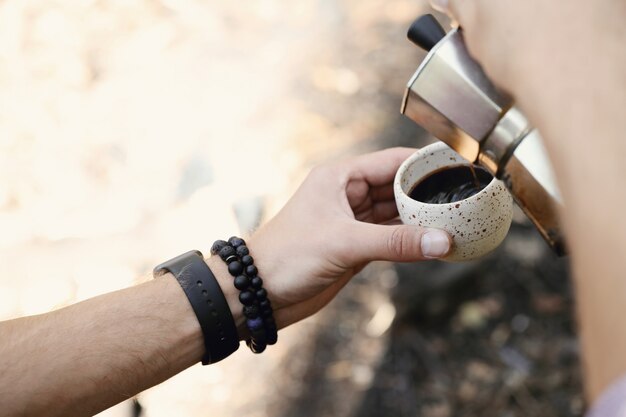 man drinking coffee in forest