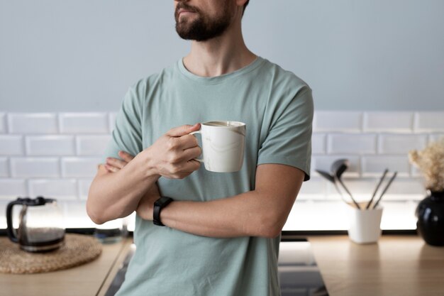 Man drinking coffee at the kitchen