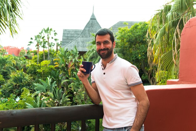 Man drinking coffee outdoors