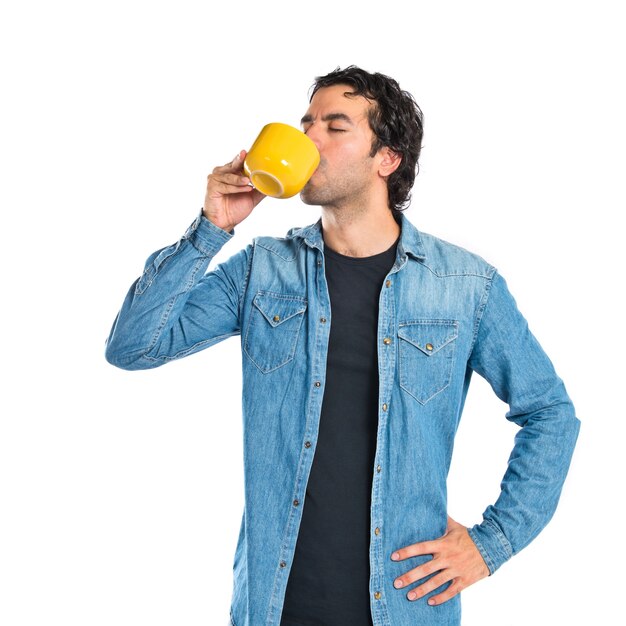 Man drinking coffee over white background