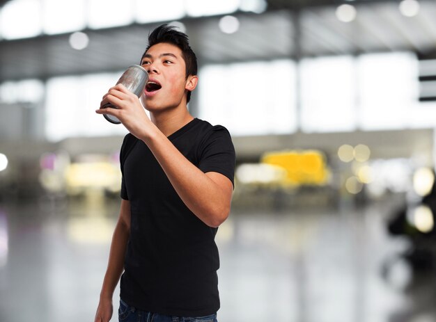 Man drinking from a big can