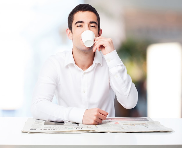 Man drinking from a cup of coffee