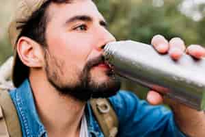 Free photo man drinking from thermos