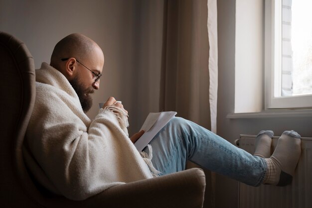 Man drinking hot beverage during energy crisis