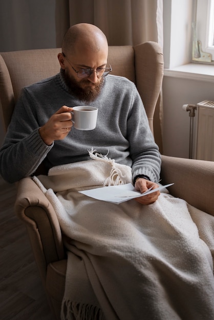 Man drinking hot beverage during energy crisis