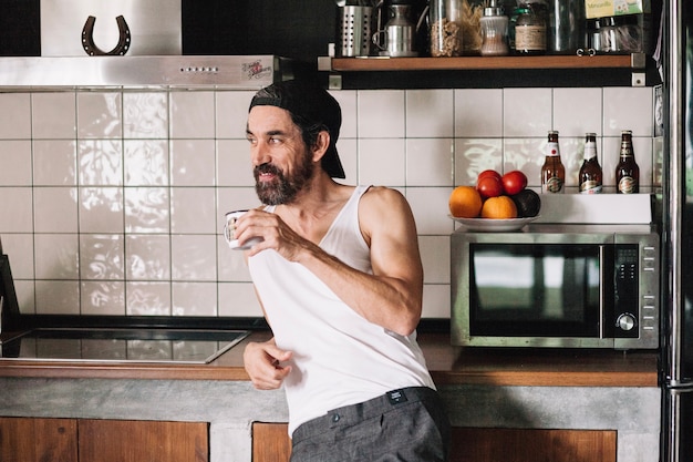 Man drinking in kitchen