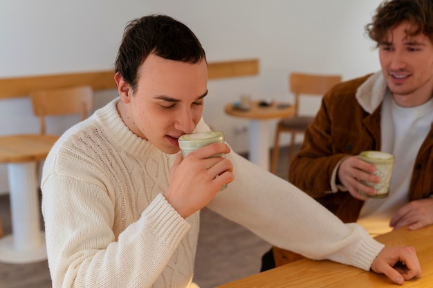 Free photo man drinking matcha tea